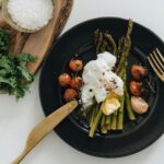 Delicious poached egg on asparagus with cherry tomatoes. Perfect for a healthy breakfast or brunch.