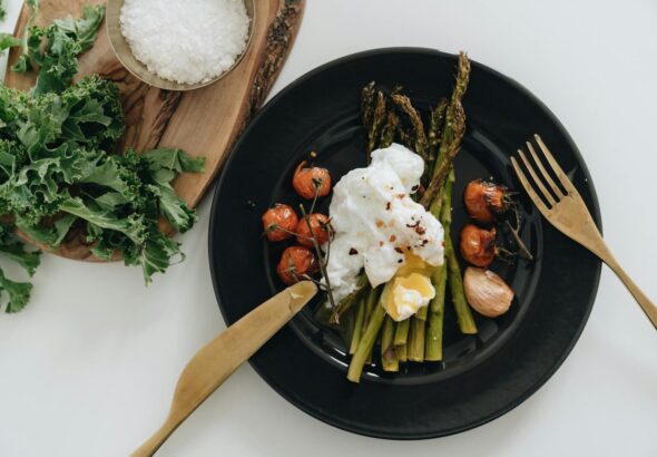 Delicious poached egg on asparagus with cherry tomatoes. Perfect for a healthy breakfast or brunch.