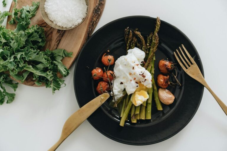 Delicious poached egg on asparagus with cherry tomatoes. Perfect for a healthy breakfast or brunch.